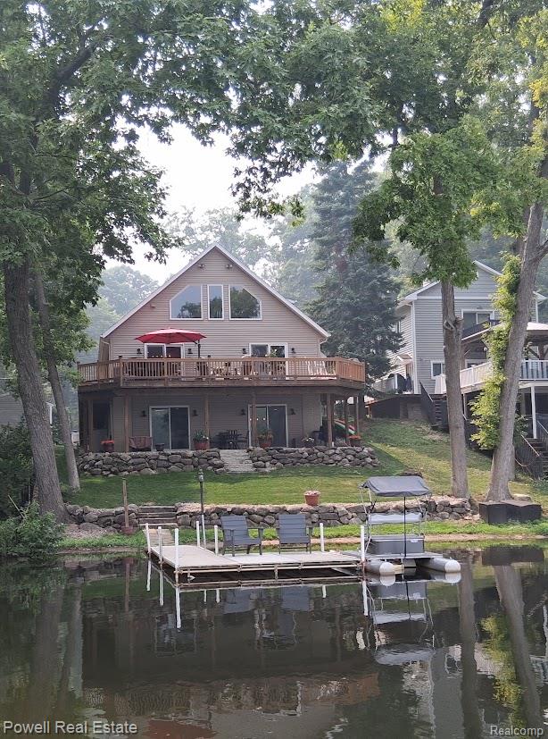6807 Big Trail Road Holly, MI 48442 - Photo 36 of 45 Waterfront residence featuring a spacious upper deck, lower patio, and private dock with a boat lift