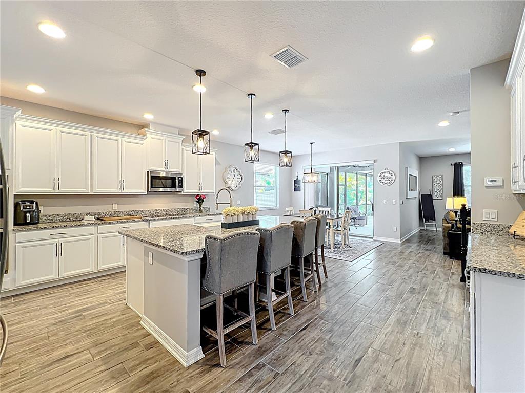 2676 Estuary Loop Oviedo, FL 32765 - Photo 13 of 92 a large white kitchen with lots of counter top space and a sink