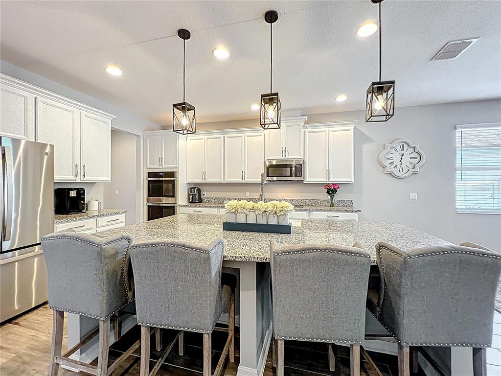 2676 Estuary Loop Oviedo, FL 32765 - Photo 16 of 92 a large kitchen with a table and chairs