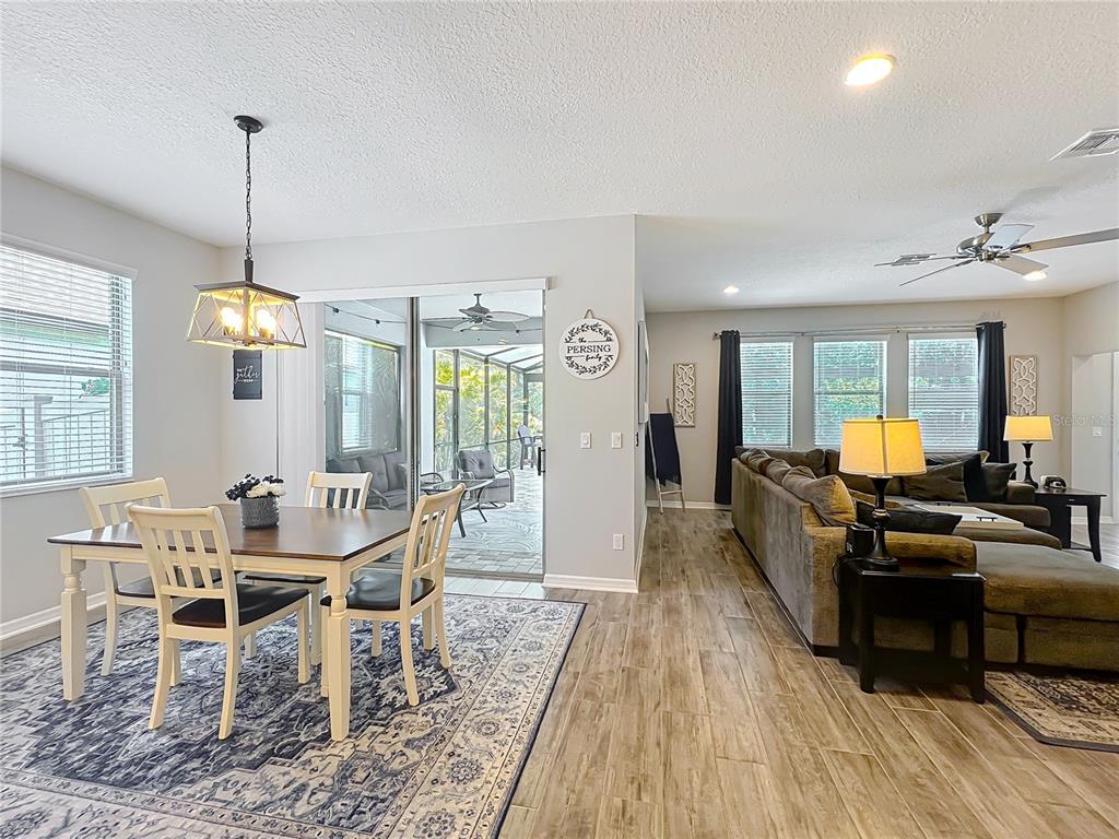 2676 Estuary Loop Oviedo, FL 32765 - Photo 26 of 92 a view of a dining room with furniture window and wooden floor