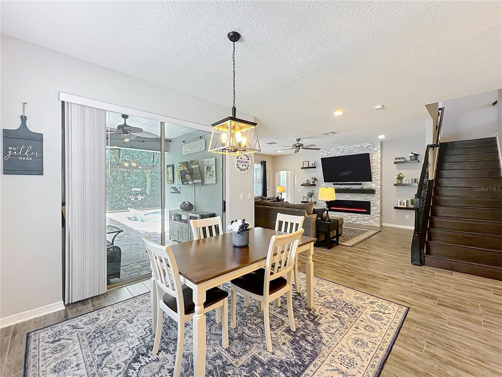 2676 Estuary Loop Oviedo, FL 32765 - Photo 27 of 92 a view of a dining room with furniture wooden floor and a chandelier