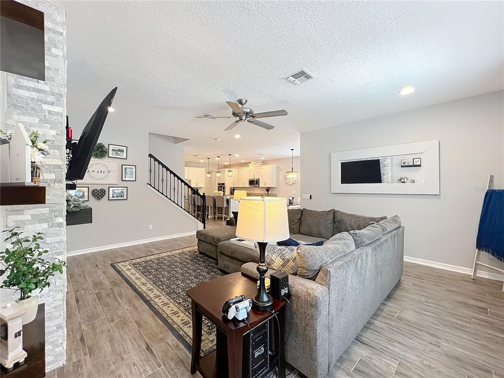 2676 Estuary Loop Oviedo, FL 32765 - Photo 29 of 92 a living room with furniture kitchen view and a wooden floor