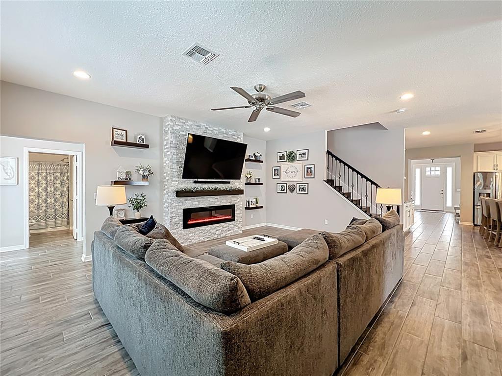 2676 Estuary Loop Oviedo, FL 32765 - Photo 30 of 92 a living room with furniture and a flat screen tv