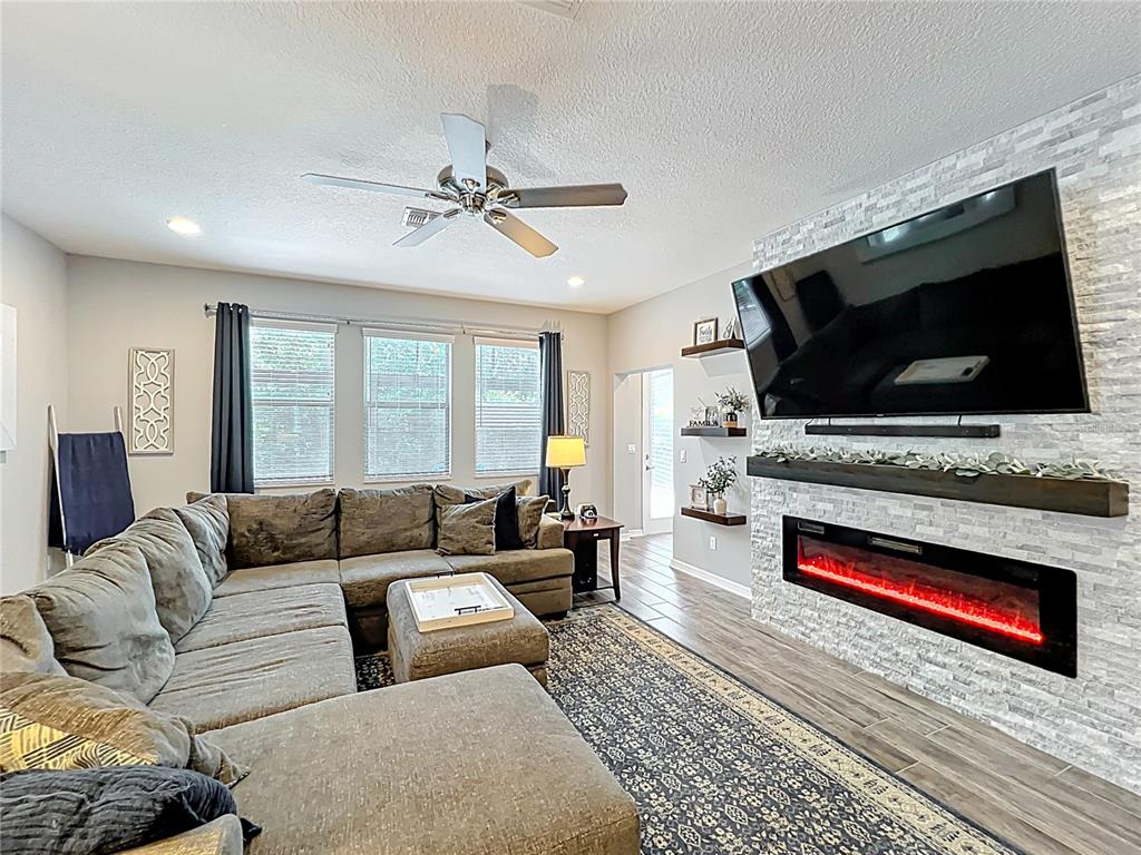 2676 Estuary Loop Oviedo, FL 32765 - Photo 32 of 92 a living room with furniture and a flat screen tv