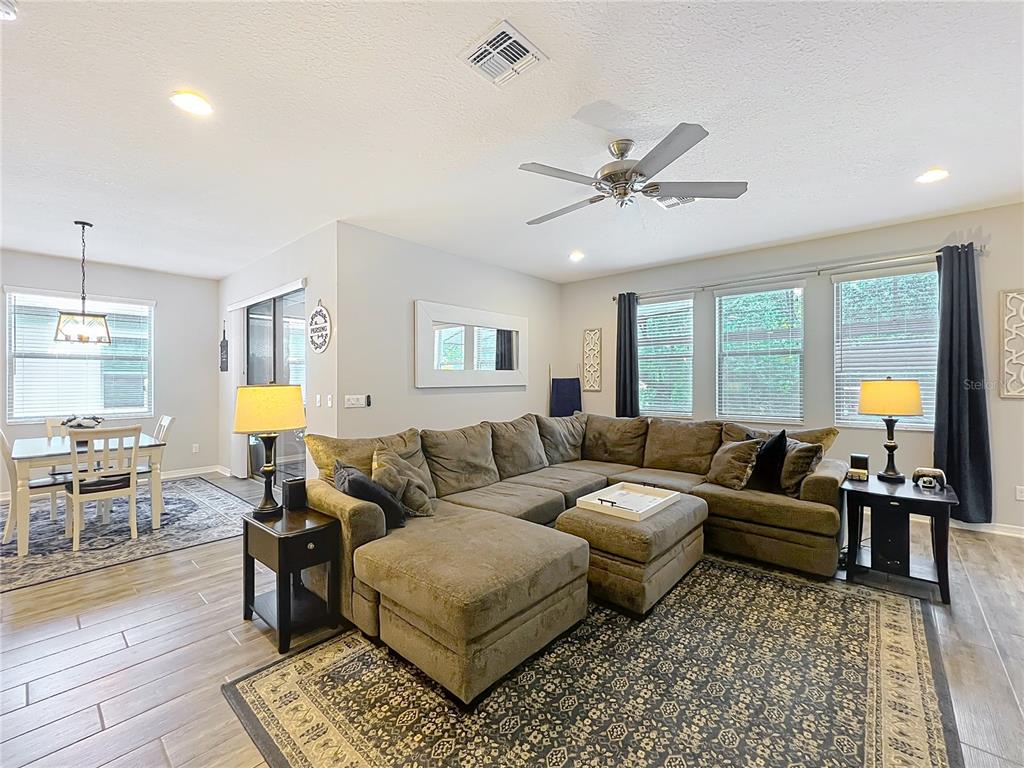 2676 Estuary Loop Oviedo, FL 32765 - Photo 34 of 92 a living room with furniture and wooden floor