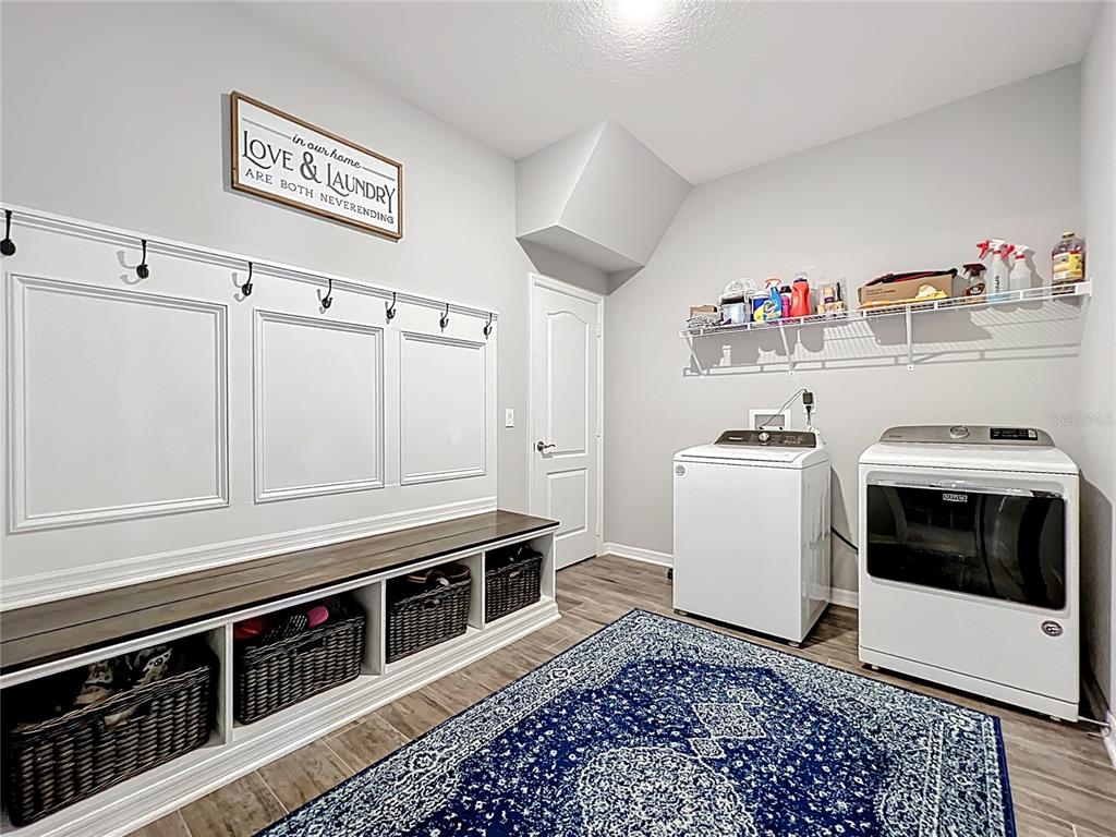 2676 Estuary Loop Oviedo, FL 32765 - Photo 37 of 92 a utility room with wooden floor washer and dryer
