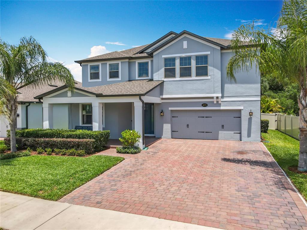 2676 Estuary Loop Oviedo, FL 32765 - Photo 4 of 92 a front view of a house with a yard