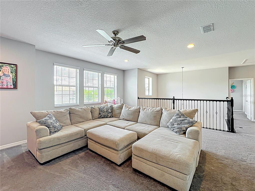 2676 Estuary Loop Oviedo, FL 32765 - Photo 46 of 92 a living room with furniture and a large window