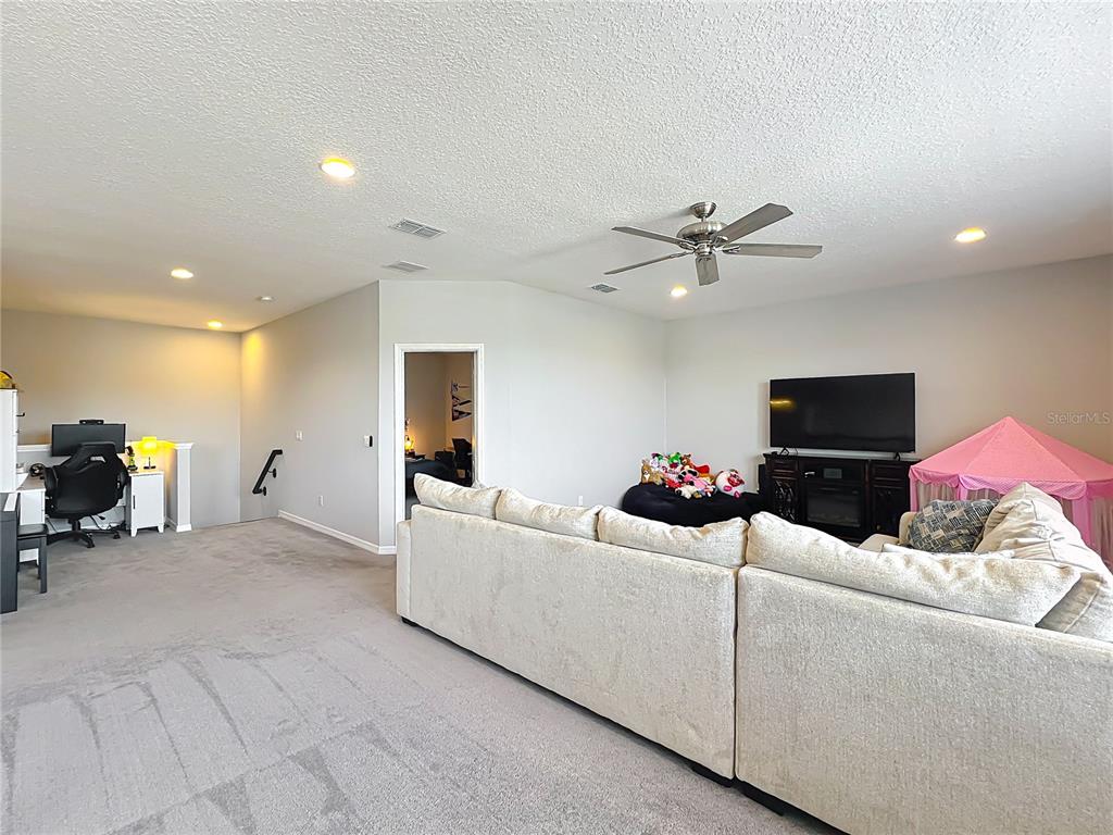 2676 Estuary Loop Oviedo, FL 32765 - Photo 49 of 92 a living room with furniture and a flat screen tv