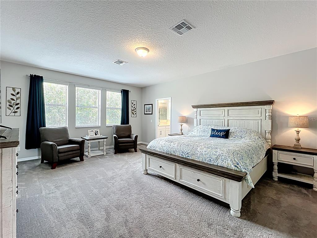 2676 Estuary Loop Oviedo, FL 32765 - Photo 50 of 92 a spacious bedroom with a bed and a large window