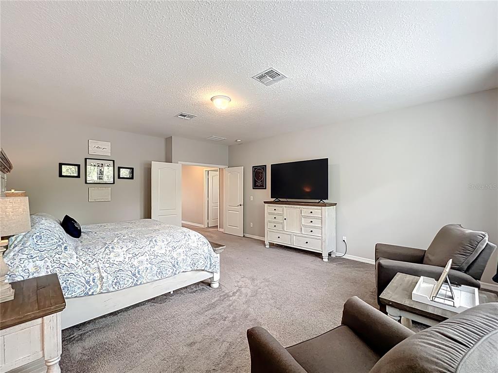 2676 Estuary Loop Oviedo, FL 32765 - Photo 52 of 92 a bedroom with furniture and a flat screen tv