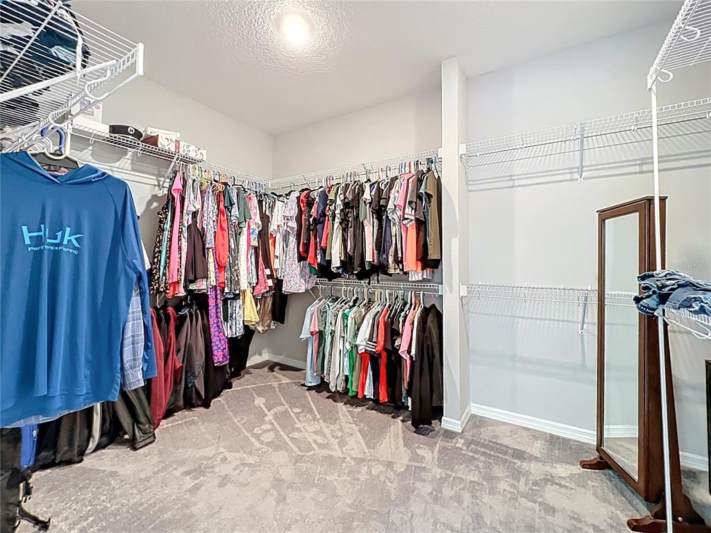 2676 Estuary Loop Oviedo, FL 32765 - Photo 57 of 92 a view of walk in closet with clothes