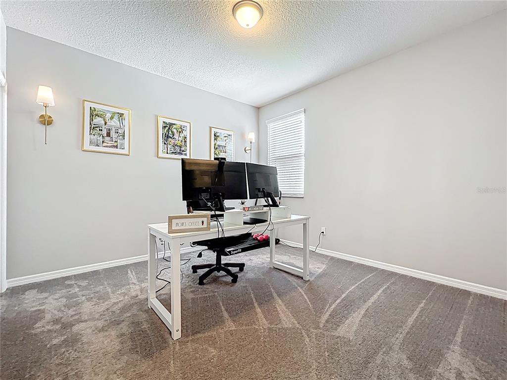 2676 Estuary Loop Oviedo, FL 32765 - Photo 60 of 92 a view of a workspace with furniture and a window