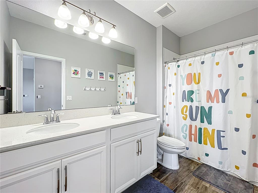 2676 Estuary Loop Oviedo, FL 32765 - Photo 64 of 92 a spacious bathroom with a toilet sink and mirror