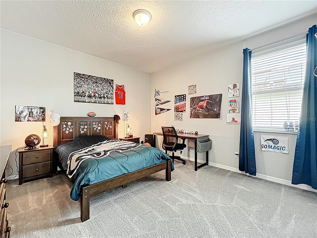 2676 Estuary Loop Oviedo, FL 32765 - Photo 65 of 92 a bedroom with a bed and a couch