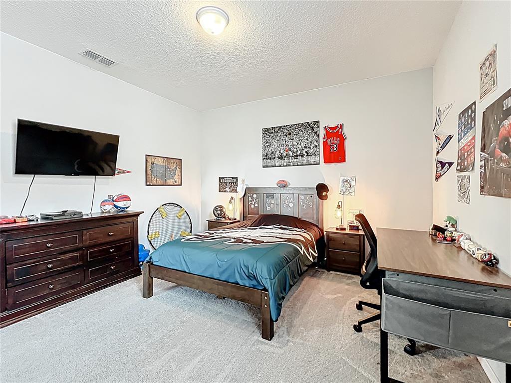 2676 Estuary Loop Oviedo, FL 32765 - Photo 66 of 92 a bedroom with a bed and a flat screen tv