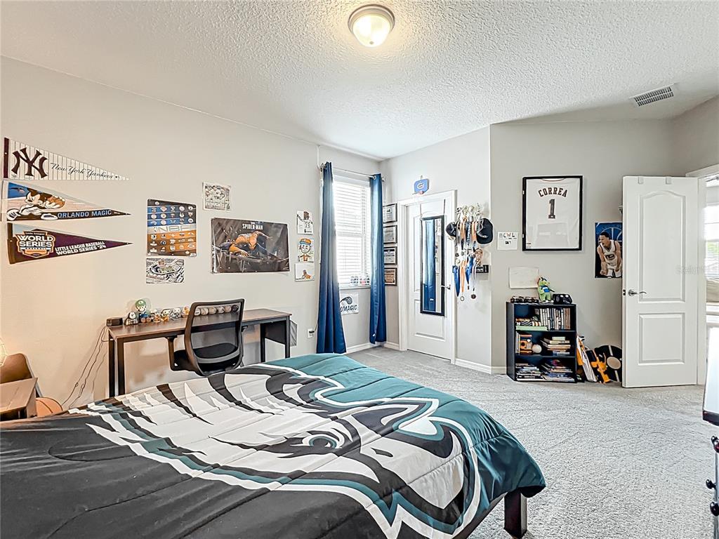 2676 Estuary Loop Oviedo, FL 32765 - Photo 67 of 92 a bedroom with a bed and a car