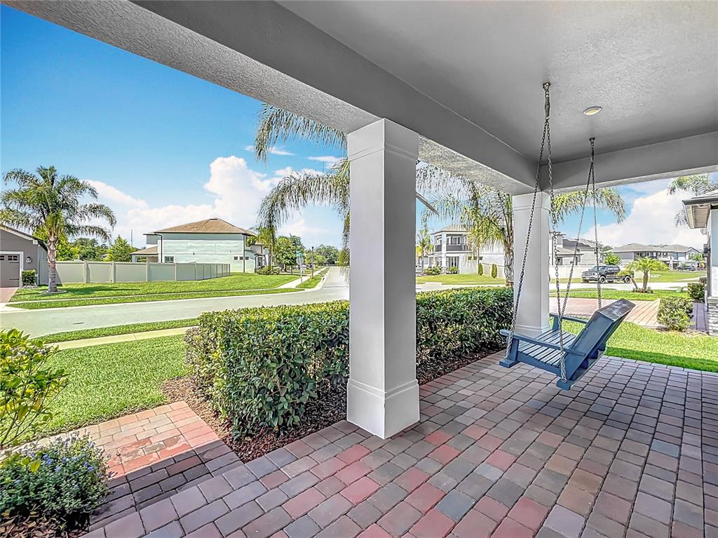 2676 Estuary Loop Oviedo, FL 32765 - Photo 7 of 92 a view of a porch with furniture and garden