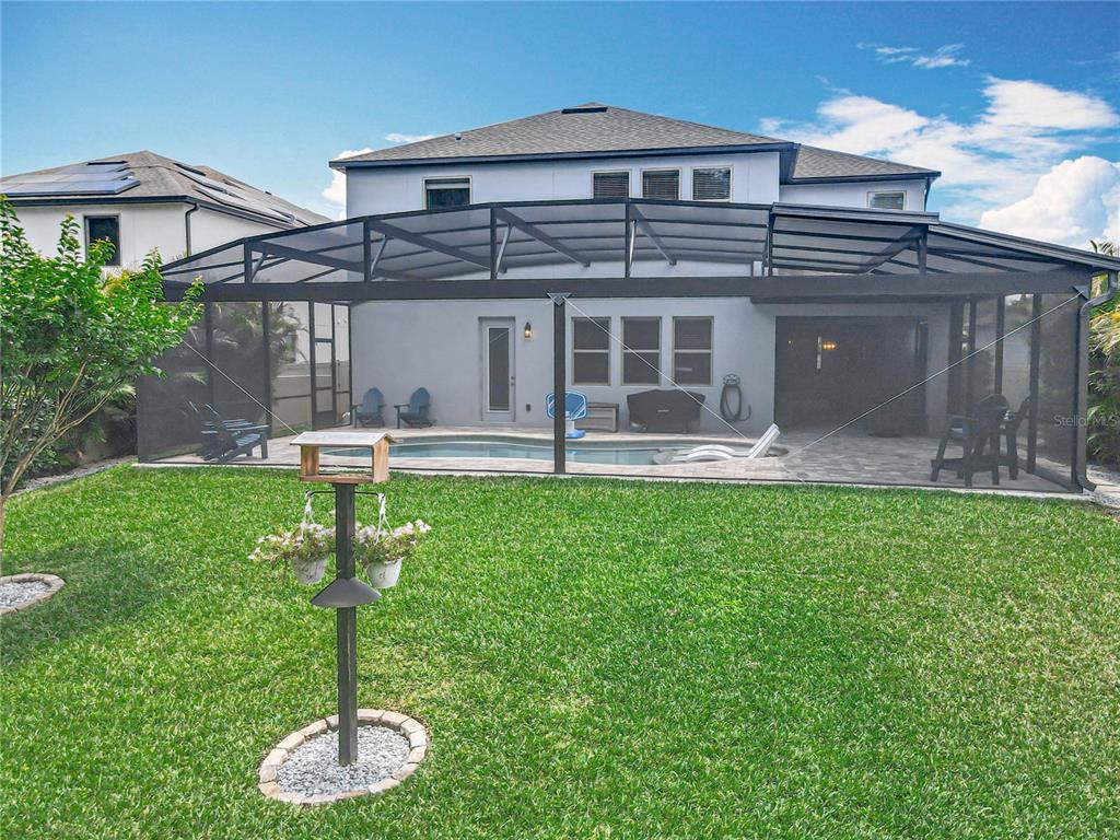 2676 Estuary Loop Oviedo, FL 32765 - Photo 82 of 92 a front view of a house with a yard fire pit and outdoor seating
