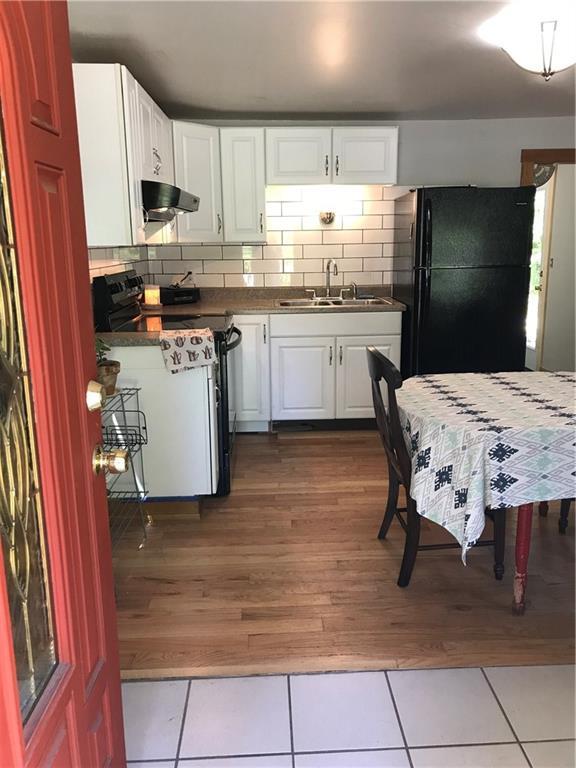 92 Webbs Mills Road Raymond, ME 04071 - Photo 9 of 30 Hardwood floors and a white tile...