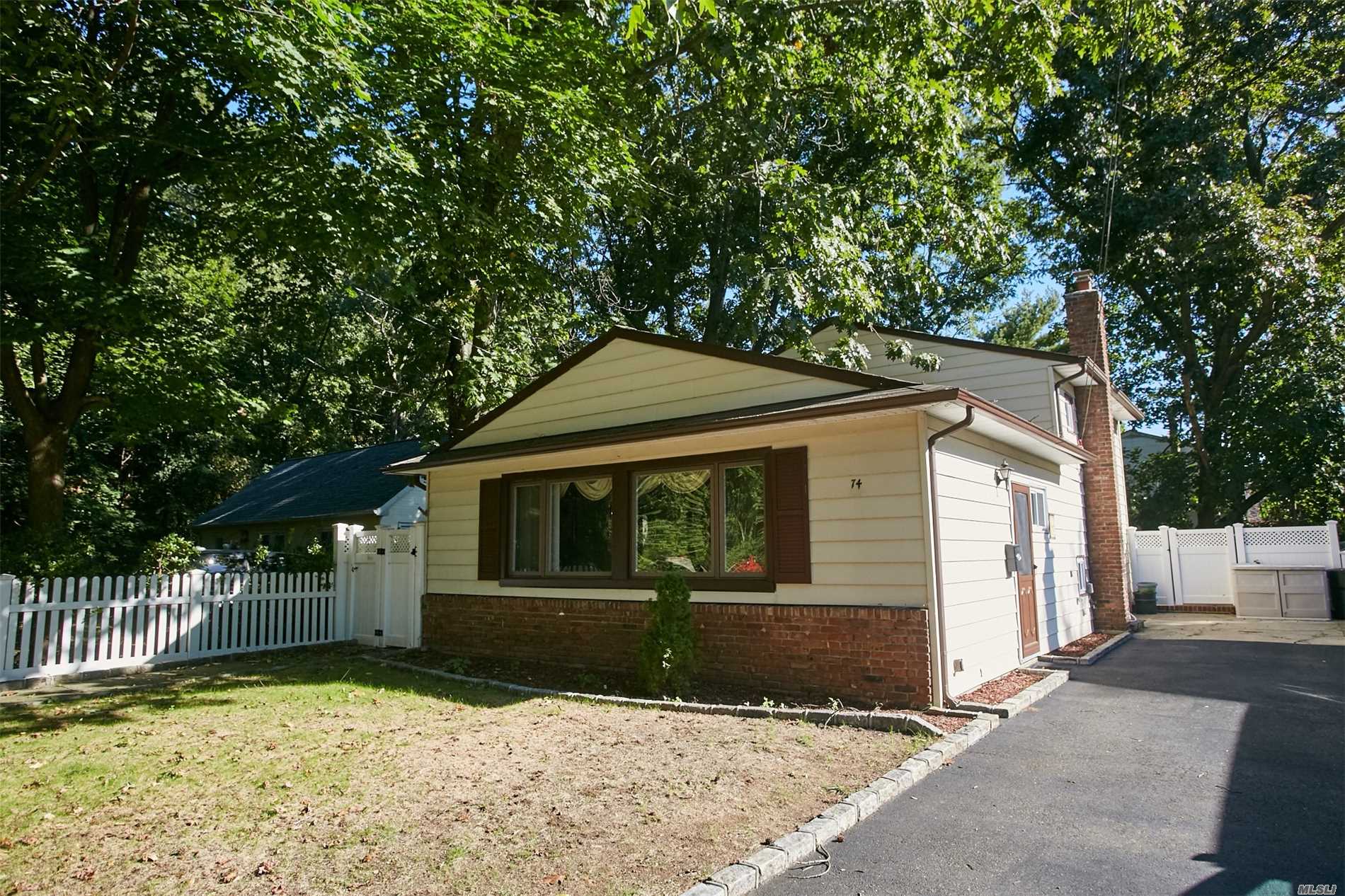 74 Juniper Road Port Washington, NY 11050 - Photo 1 of 1 a front view of a house with a yard