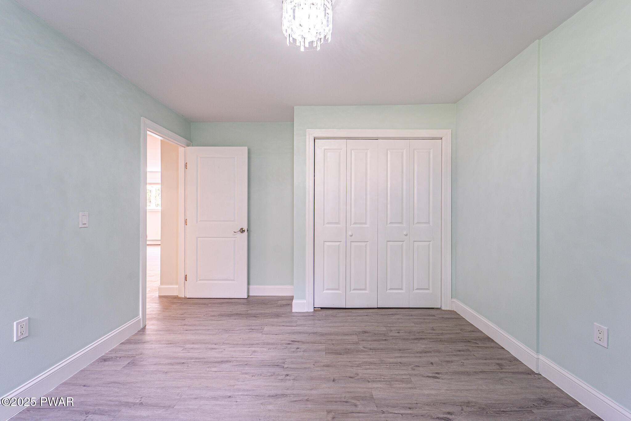 153 Hatton Road Hawley, PA 18428 - Photo 29 of 38 an empty room with wooden floor and windows