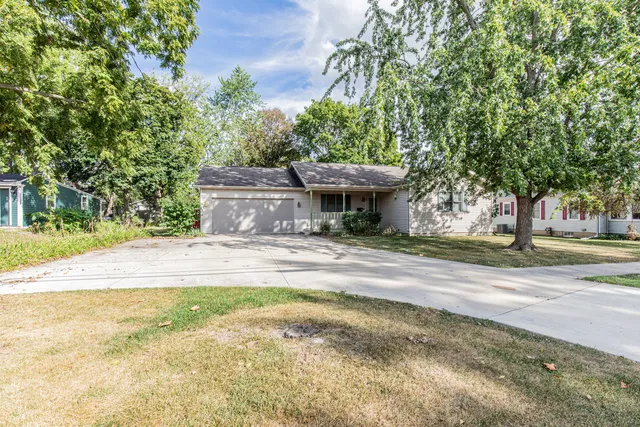 a view of a house with a yard and tree s