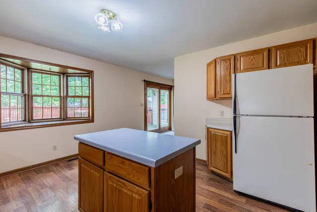 a kitchen with a refrigerator and a table