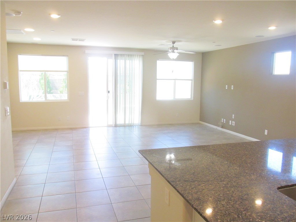 2157 Rio Rancho Pointe Place Henderson, NV 89002 - Photo 8 of 24 A spacious living area offers abundant light, durable tile flooring, and a versatile layout for everyday living.