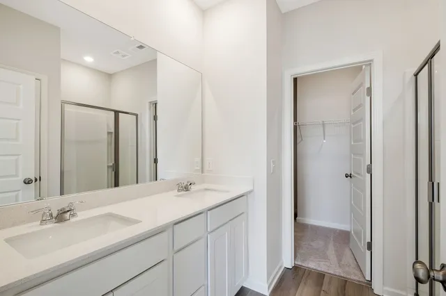 a bathroom with a double vanity sink mirror and double