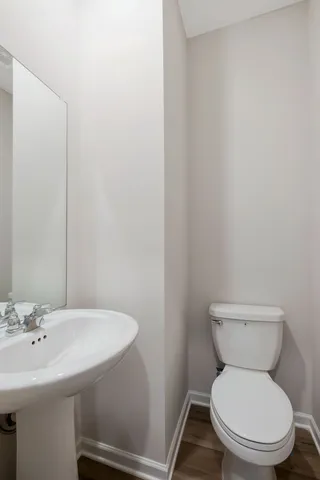 a white toilet sitting next to a white sink