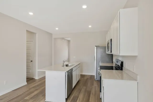 a view of a kitchen with electric appliances
