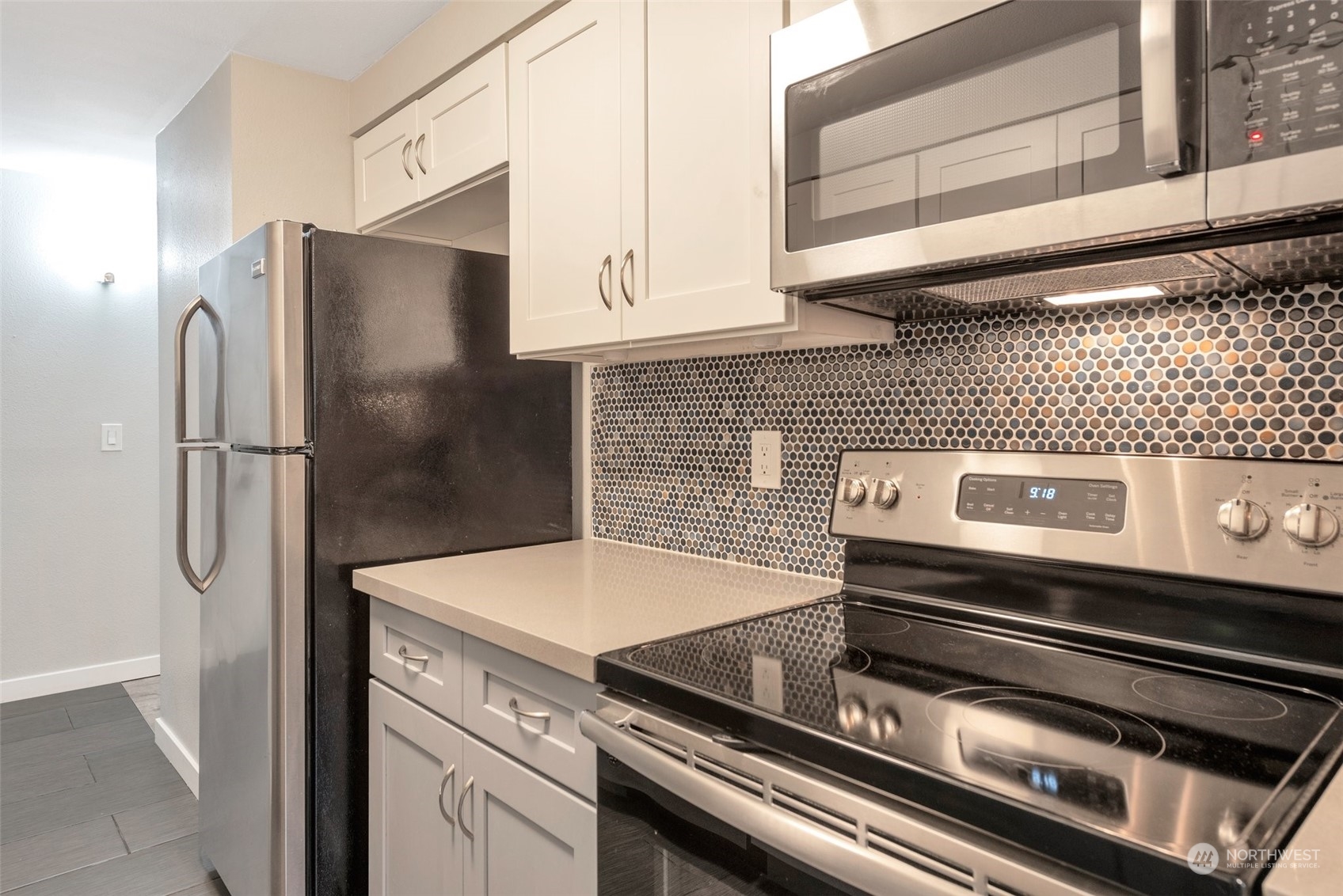 12119 Bel-Red Road, Unit B203 Bellevue, WA 98005 - Photo 7 of 15 a close view of a stove top oven and refrigerator