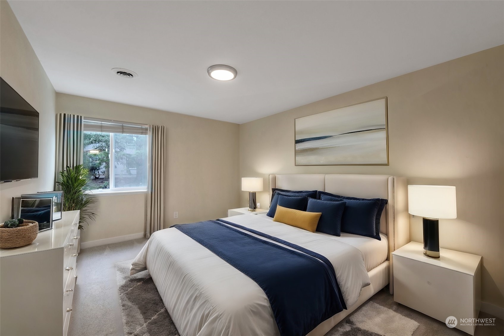 12119 Bel-Red Road, Unit B203 Bellevue, WA 98005 - Photo 8 of 15 a bedroom with a bed and a flat screen tv
