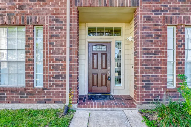 a front view of a building with a garden