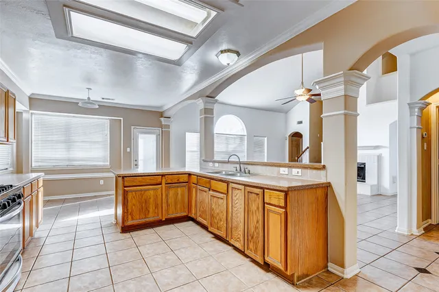a large kitchen with stainless steel appliances granite countertop a sink and cabinets