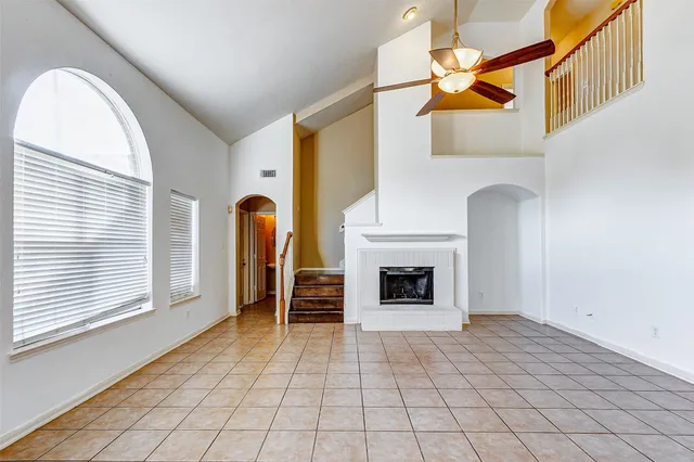 a view of a livingroom with a fireplace and window