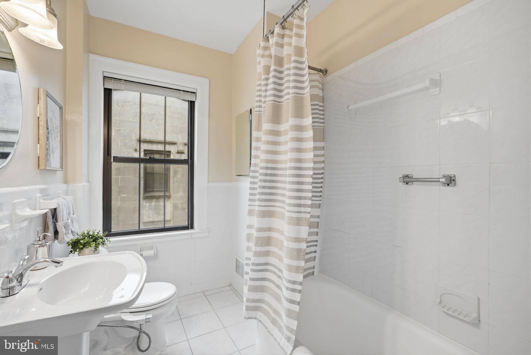 1613 Harvard Street Northwest, Unit 501 Washington, DC 20009 - Photo 14 of 25 Bright and airy bathroom with modern touches.