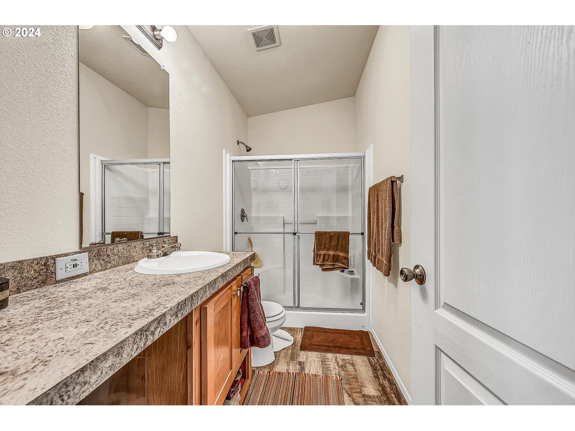69911 Walker Road Rainier, OR 97048 - Photo 15 of 26 a bathroom with a granite countertop sink a toilet and shower