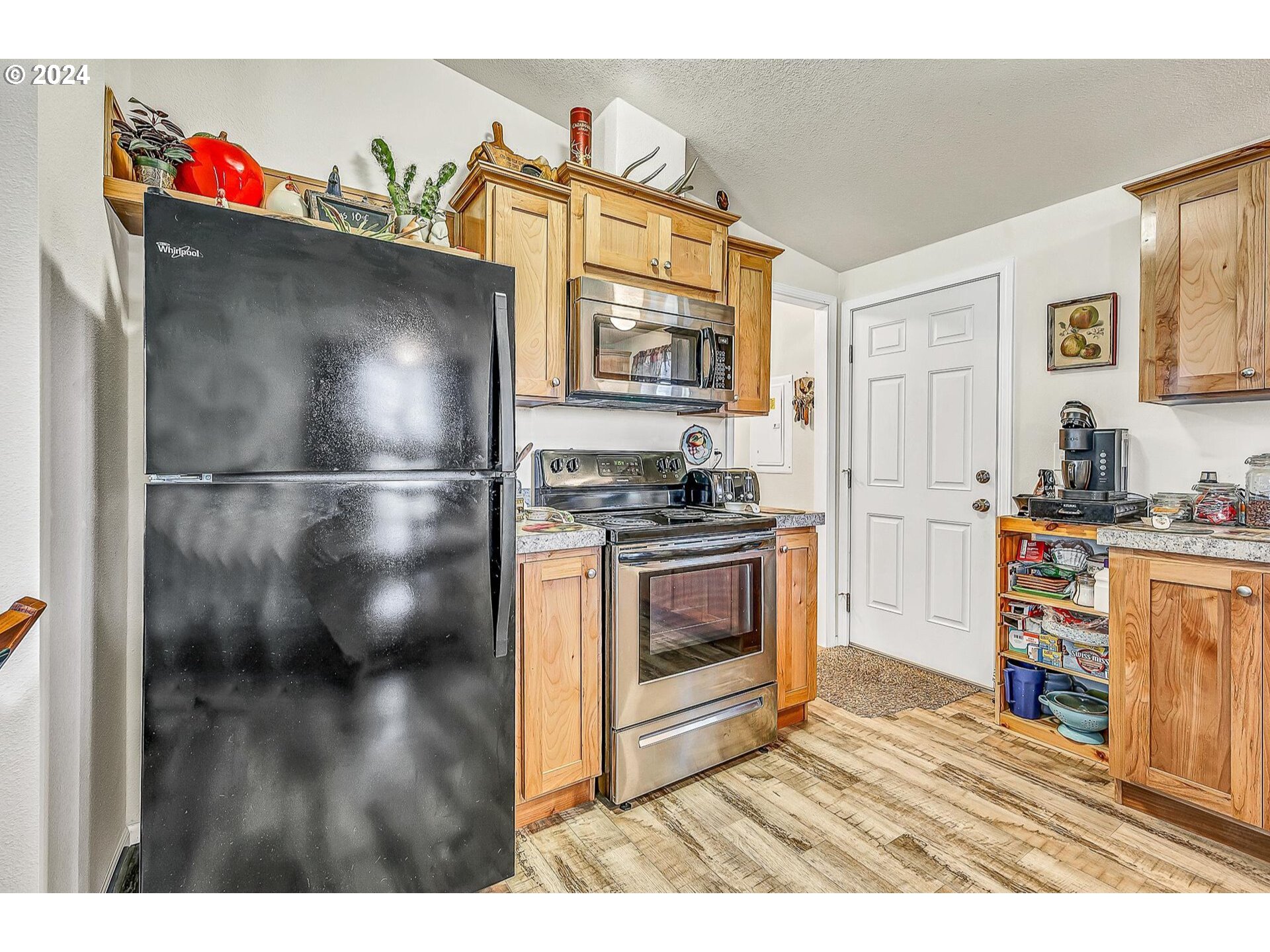 69911 Walker Road Rainier, OR 97048 - Photo 10 of 26 a kitchen with granite countertop a refrigerator and a stove top oven