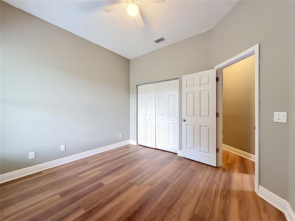 28549 Shirley Shores Road Tavares, FL 32778 - Photo 34 of 65 a view of an empty room with wooden floor
