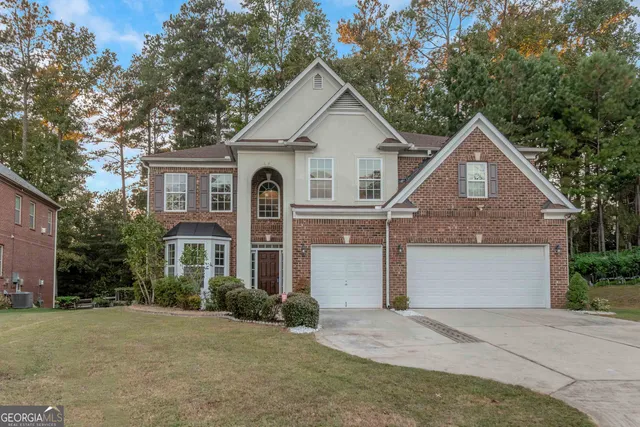 a front view of a house with a yard and garage