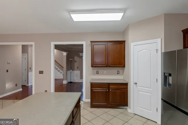 a spacious bathroom with a granite countertop sink and a mirror