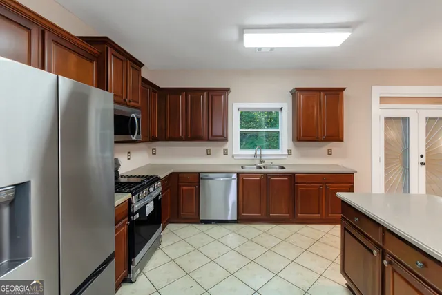 a kitchen with stainless steel appliances granite countertop a refrigerator stove and sink