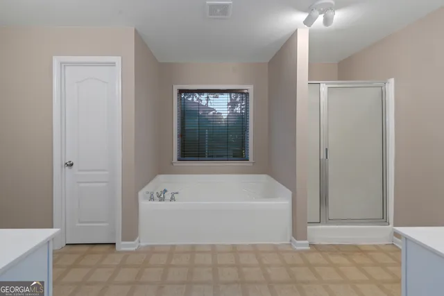 a bathroom with a bathtub and shower