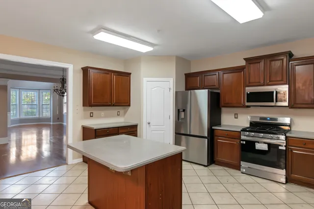 a kitchen with stainless steel appliances a stove refrigerator and microwave