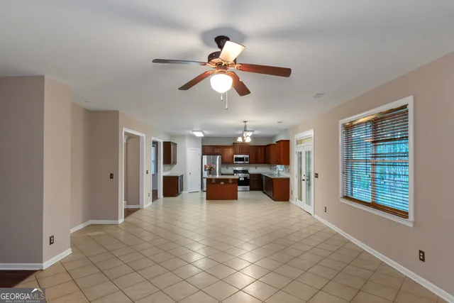 a view of a livingroom with furniture and a ceiling fan