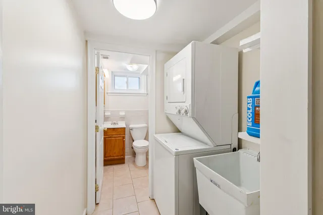 a utility room with a sink dryer and washer