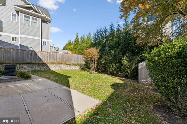 a view of a house with a yard and pathway