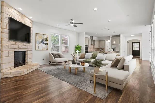 a living room with fireplace furniture and a flat screen tv